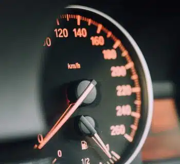 closeup photo of black analog speedometer