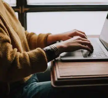 person sitting front of laptop