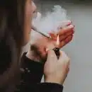 woman lights her cigarette with lighter