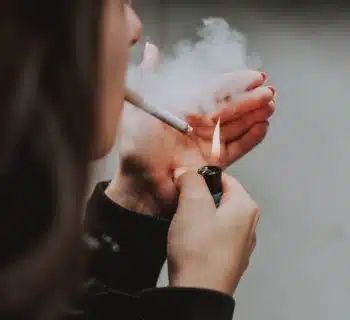 woman lights her cigarette with lighter